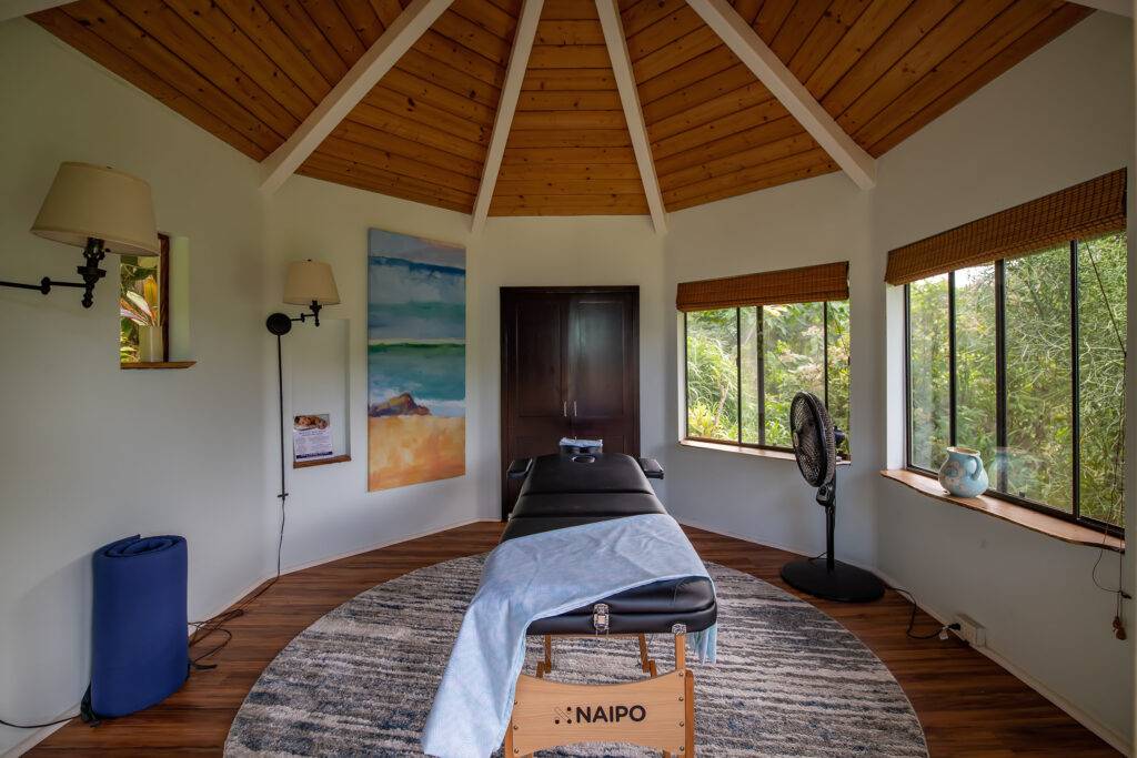 Cottage gazebo interior with massage table facing wardrobe