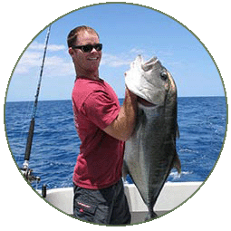 Man and a caught fish on Maui