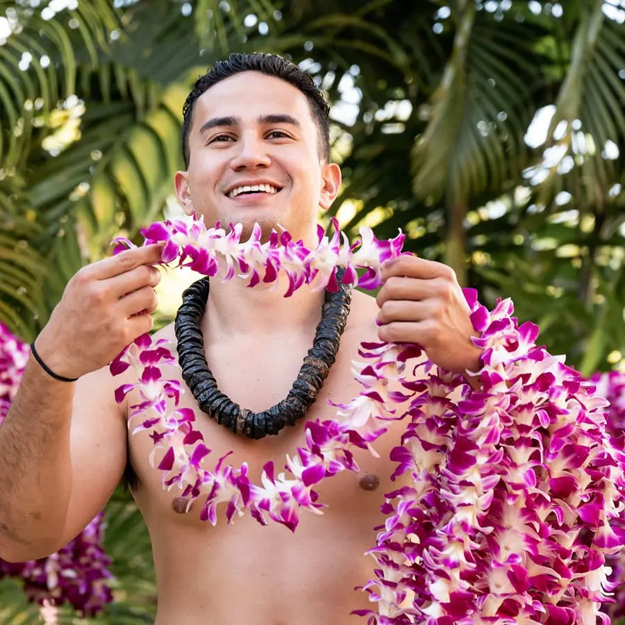 A man shares leis at Old Lahaina Luau